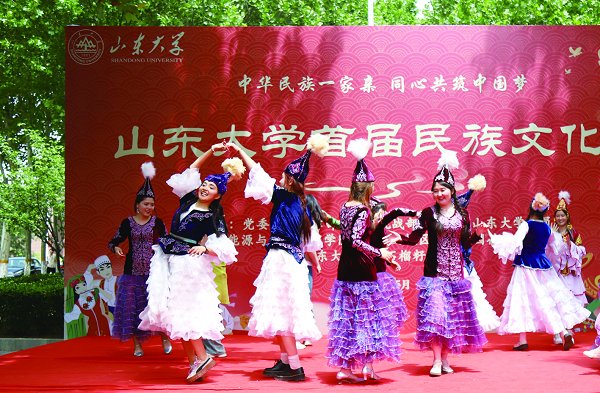 图②:5月11日,山东大学首届民族文化节在兴隆山校区举行,校党委副书记王君松为山东大学学生石榴籽爱心社授旗。此次活动以“中华民族一家亲·同心共筑中国梦”为主题,活动分为主题文化区、民族才艺展示区、民族特色体验区和石榴籽驿站四个区域。 (摄/韩婧)